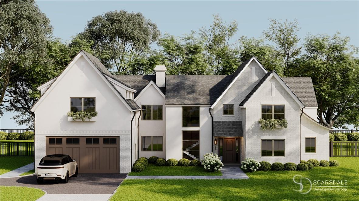 View of front of house with a garage and a front lawn