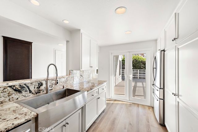 a kitchen with a sink and a refrigerator