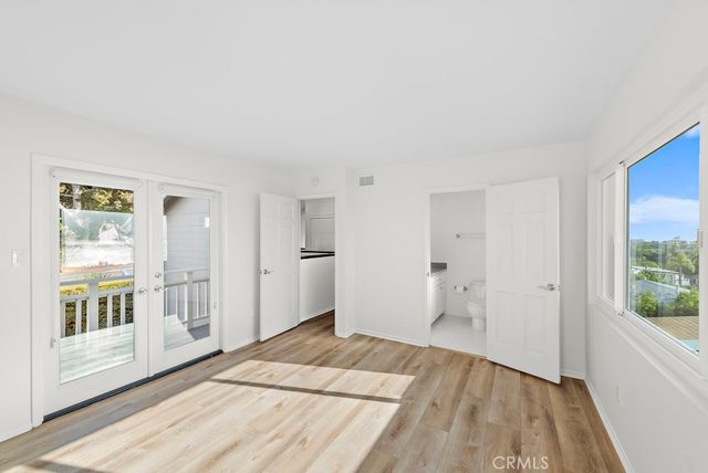 a big room with wooden floor and windows