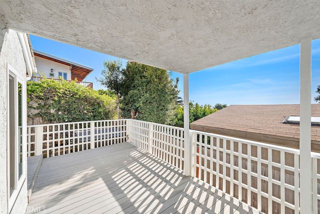 a view of a balcony with wooden floor