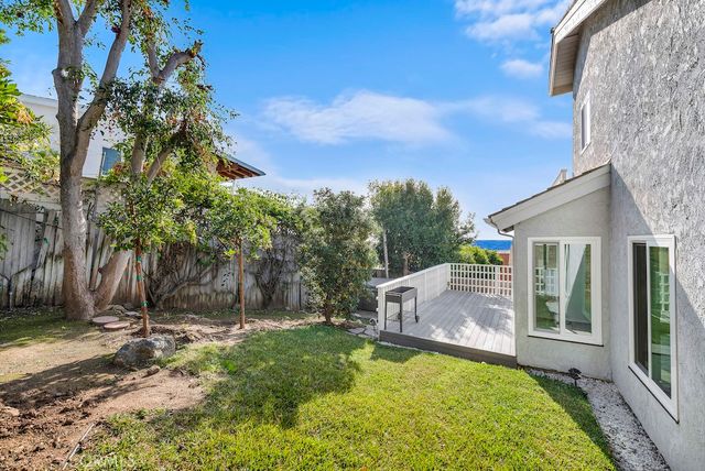a view of a house with backyard and sitting area