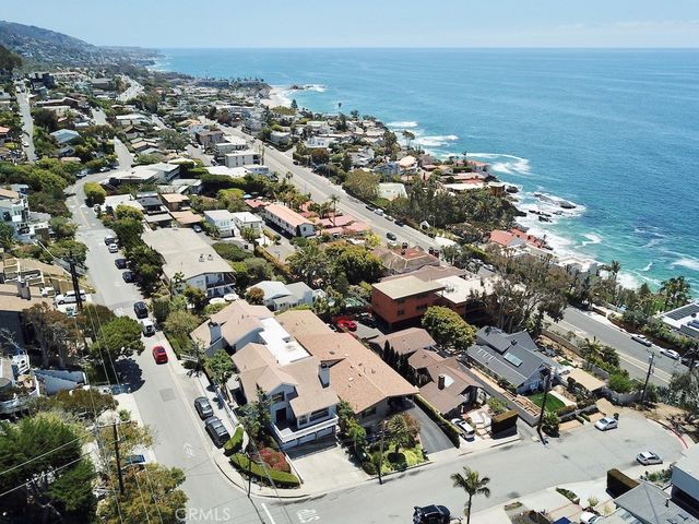 an aerial view of a city with ocean view