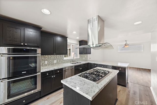 a kitchen with a stove a sink and a refrigerator