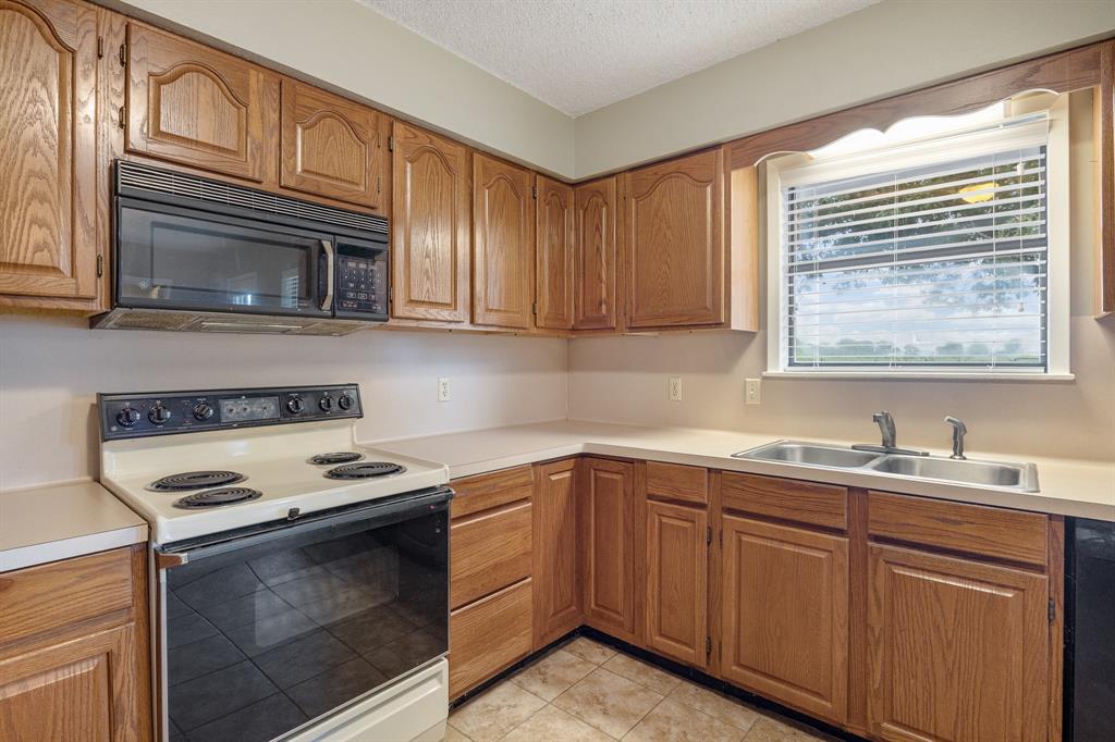24264 State Highway Canton, TX 75103 - Photo 12 of 38 a kitchen with stainless steel appliances a stove sink and microwave