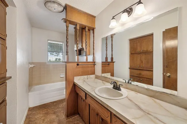 a bathroom with a sink and a mirror