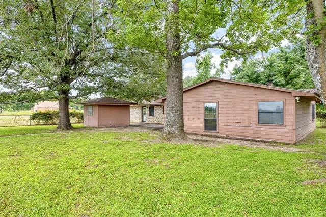 a house that has a tree in front of the house