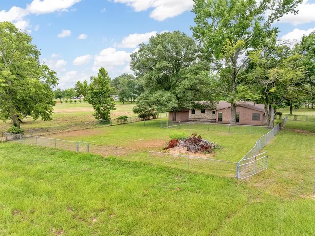 a view of a swimming pool with a yard