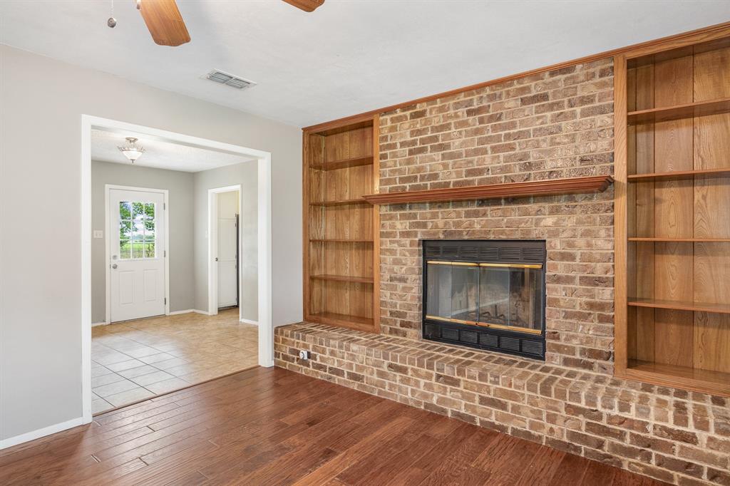 24264 State Highway Canton, TX 75103 - Photo 7 of 38 a view of an empty room with glass door and wooden floor