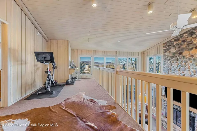 a bed sitting in a spacious bedroom next to a window