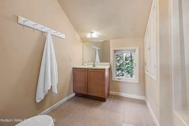 a kitchen with a sink and a stove top oven with wooden floor