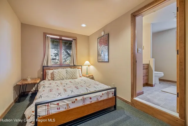 an aerial view of a house with a yard and large trees