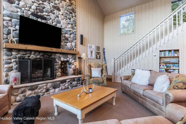 a living room with furniture and a chandelier