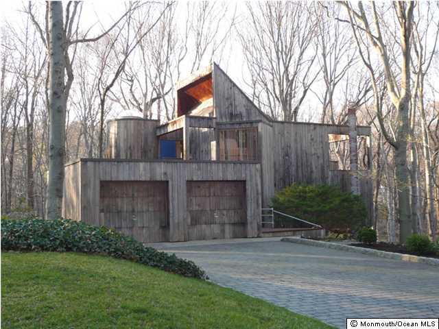 a front view of a house with a garden and plants