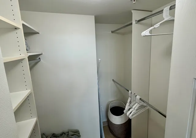 a bedroom with a bed and a lamp