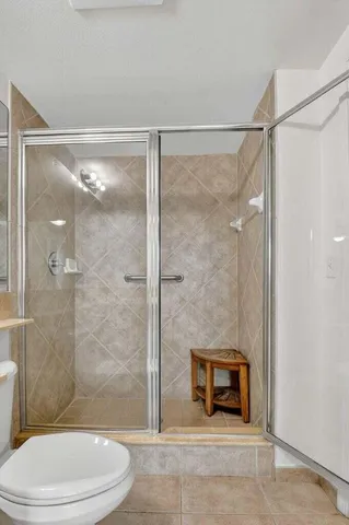 a bathroom with a sink and mirror with toilet