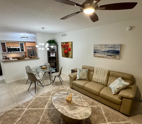 a view of a swimming pool with lawn chairs under an umbrella