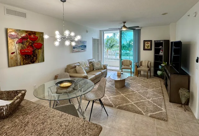 a living room with furniture a window and a flat screen tv