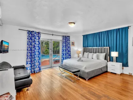 a spacious bedroom with a bed and a table in it