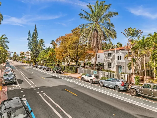 a view of a city street with cars