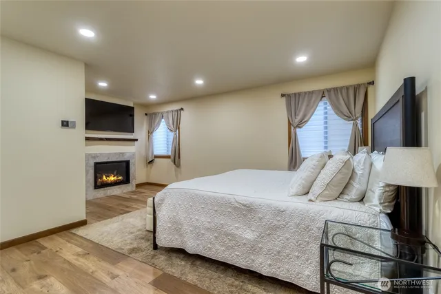 a spacious bedroom with a bed and a fireplace