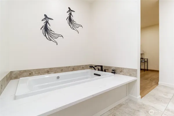 a bathroom with a tub and a shower