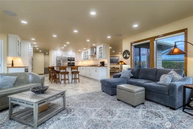 a living room with furniture and kitchen view