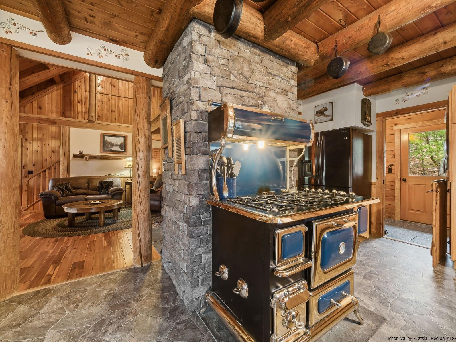 815 Peak Road Stone Ridge, NY 12484 - Photo 13 of 35 a kitchen with a stove and a refrigerator