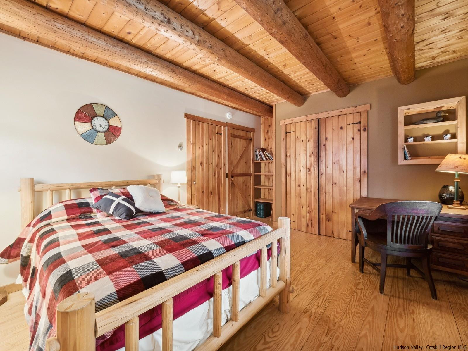 815 Peak Road Stone Ridge, NY 12484 - Photo 18 of 35 a bedroom with a bed and a table