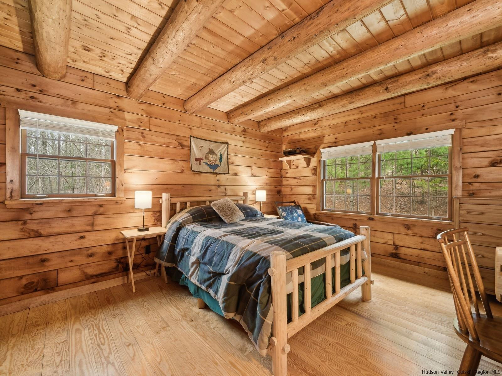 815 Peak Road Stone Ridge, NY 12484 - Photo 19 of 35 a bedroom with a bed next to a large window