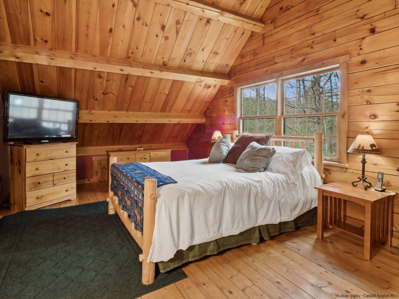 815 Peak Road Stone Ridge, NY 12484 - Photo 24 of 35 a bedroom with a bed and furniture