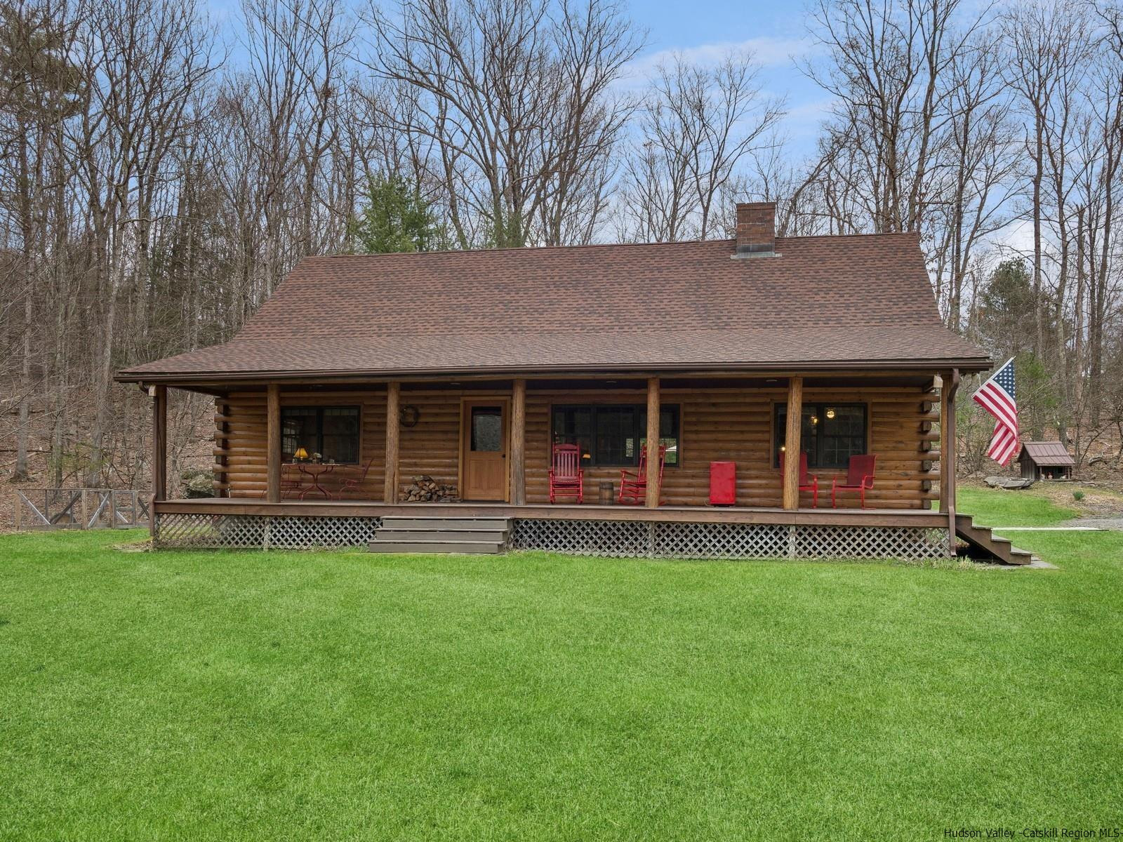 815 Peak Road Stone Ridge, NY 12484 - Photo 33 of 35 a front view of a house with a garden and trees
