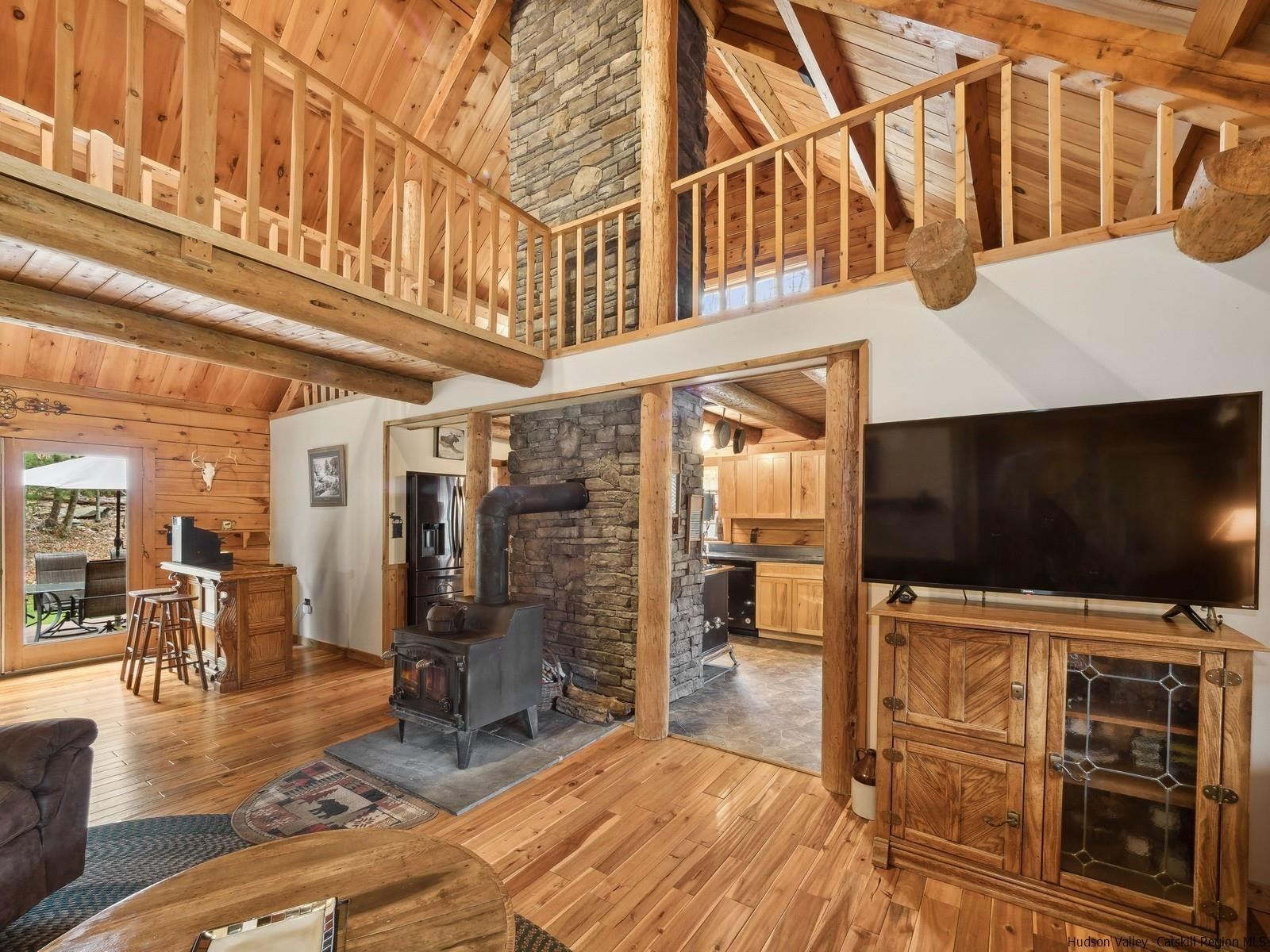 815 Peak Road Stone Ridge, NY 12484 - Photo 6 of 35 a living room with stainless steel appliances kitchen island granite countertop a rug a stove and a wooden floors
