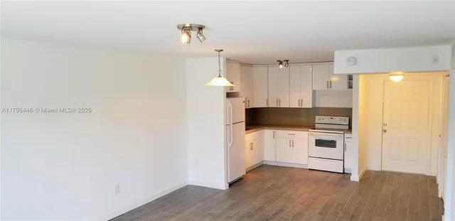 a kitchen with a refrigerator and a stove