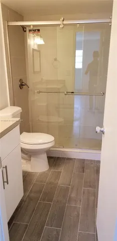 a bathroom with a toilet and a shower
