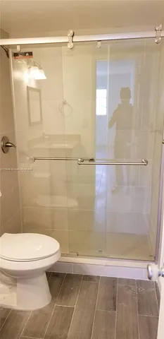 a bathroom with a toilet and a shower