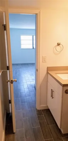 a view of a bathroom from a hallway