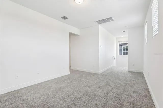 a view of an empty room and entryway