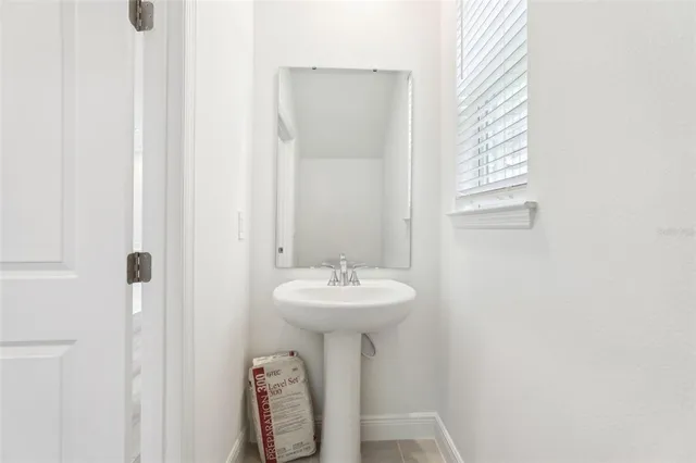 a bathroom with a double vanity sink and mirror