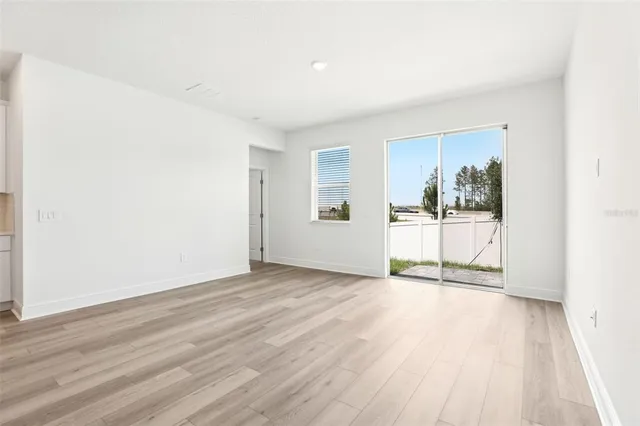 a view of a room with wooden floor and door