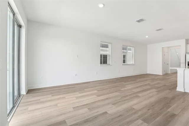 a view of kitchen with granite countertop cabinets and refrigerator