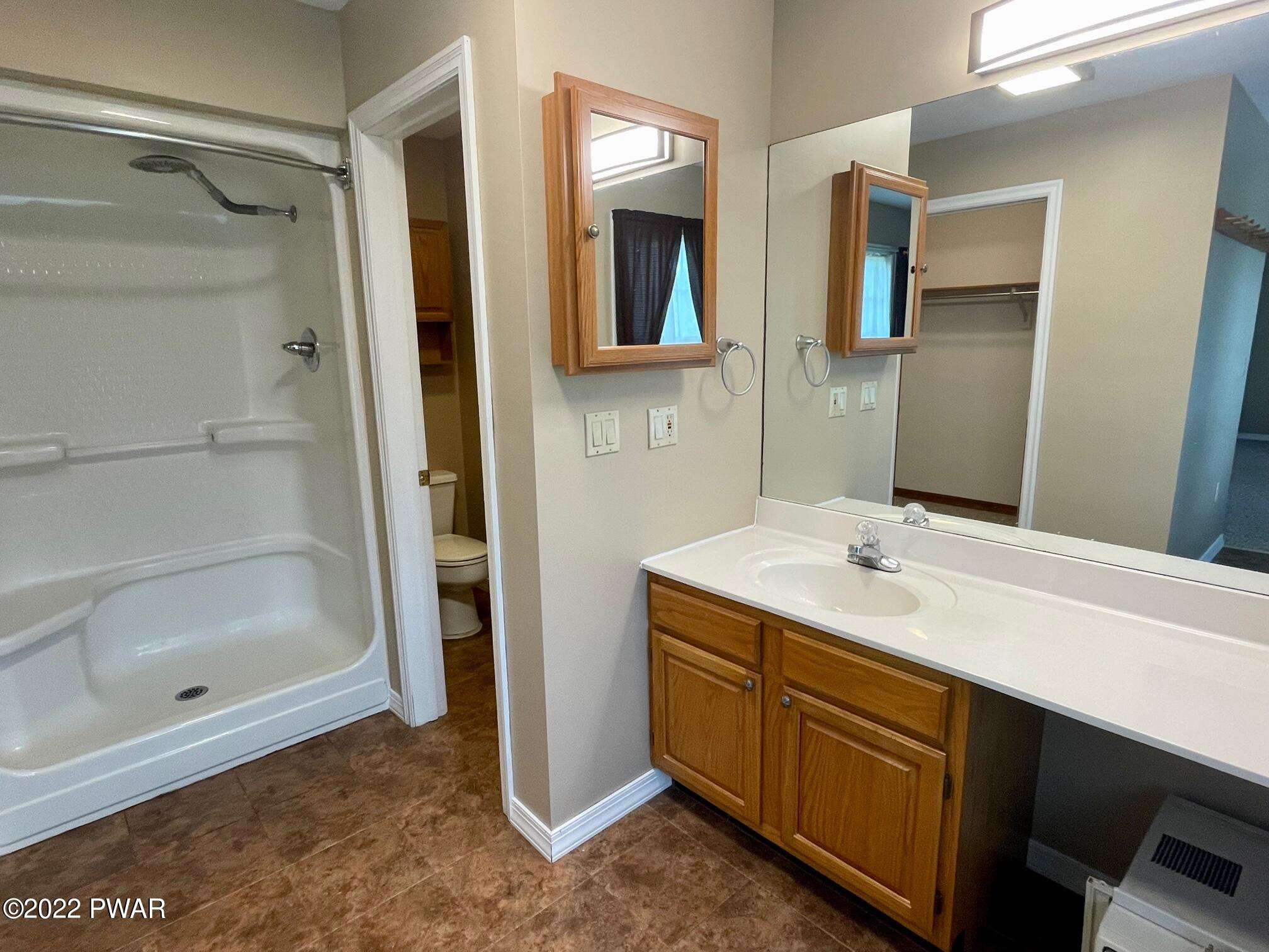 524 Creamton Drive Prompton, PA 18456 - Photo 37 of 57 a bathroom with a shower sink and mirror