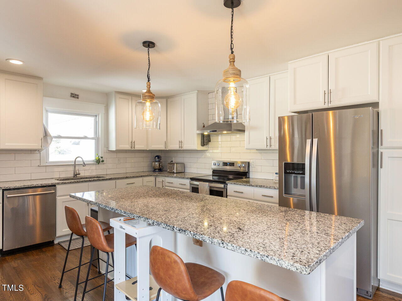 125 Crestview Drive Durham, NC 27712 - Photo 11 of 30 a kitchen with stainless steel appliances granite countertop a kitchen island a stove a table and chairs