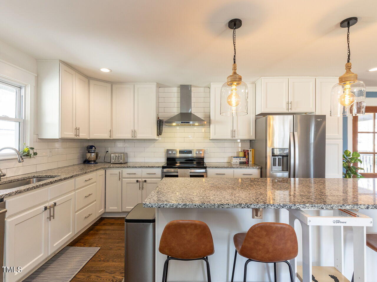 125 Crestview Drive Durham, NC 27712 - Photo 14 of 30 a kitchen with stainless steel appliances granite countertop a sink a stove a refrigerator a dining table and chairs
