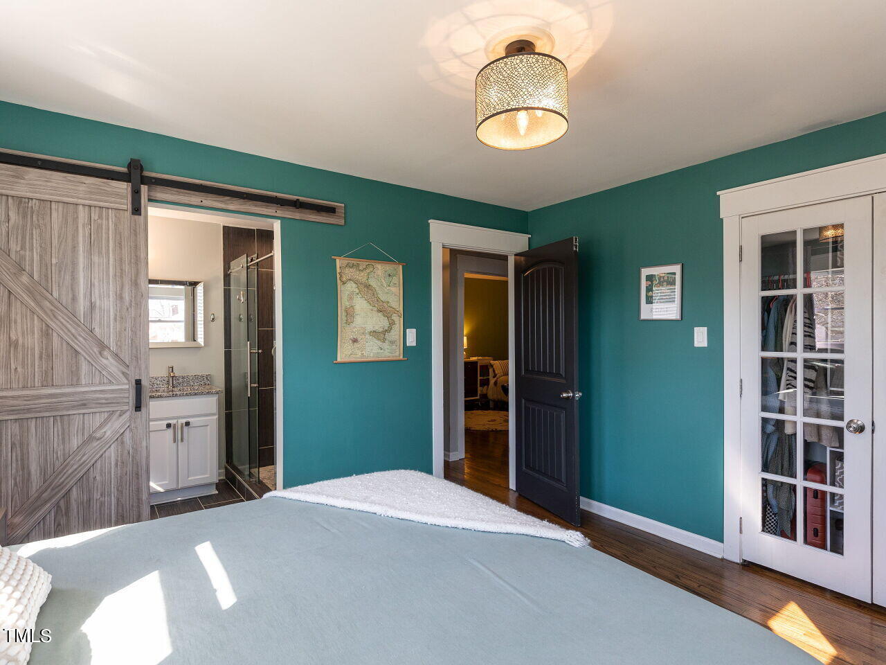 125 Crestview Drive Durham, NC 27712 - Photo 19 of 30 a bedroom with a bed and a chandelier