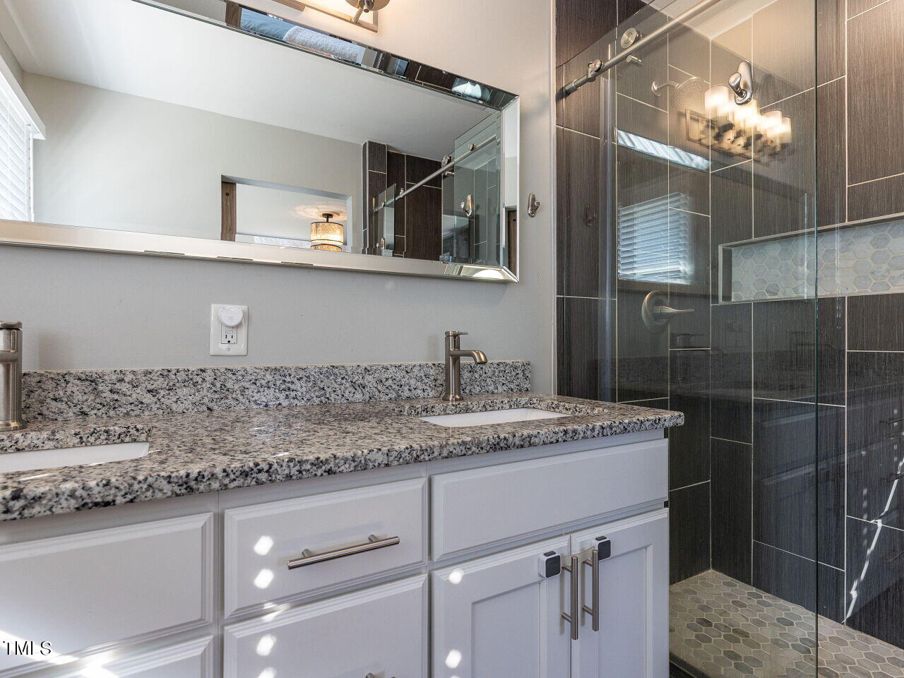 125 Crestview Drive Durham, NC 27712 - Photo 21 of 30 a bathroom with a granite countertop sink a mirror and vanity