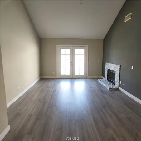 an empty room with wooden floor and a window