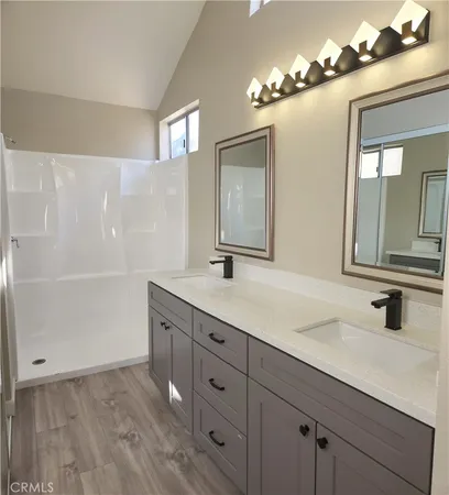 a bathroom with a double vanity sink and a mirror