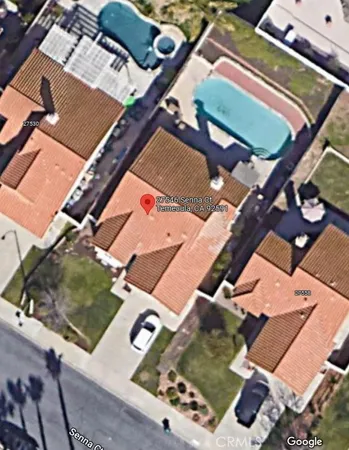 an aerial view of a house with a yard