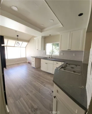 a kitchen with stainless steel appliances granite countertop a sink stove and cabinets