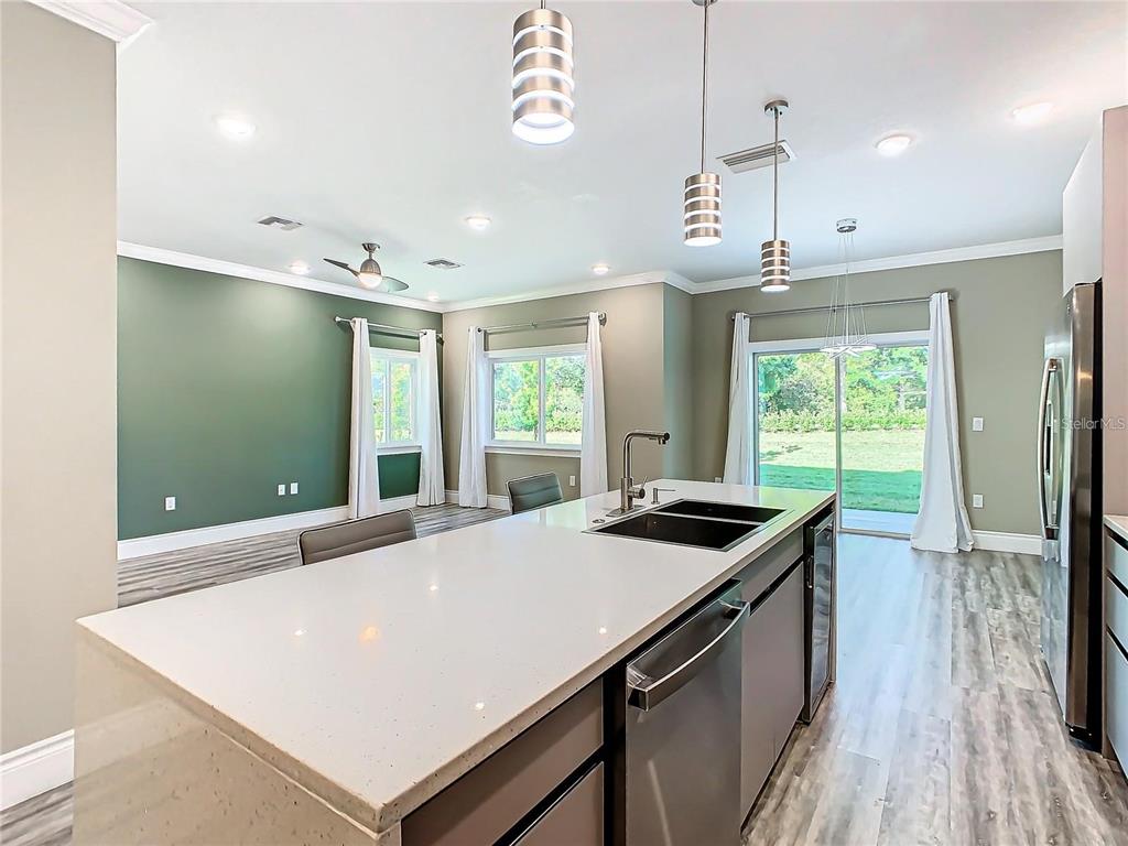 2000 Greenbriar Terrace Davenport, FL 33837 - Photo 12 of 50 a kitchen that has a microwave a stove and a wooden floor